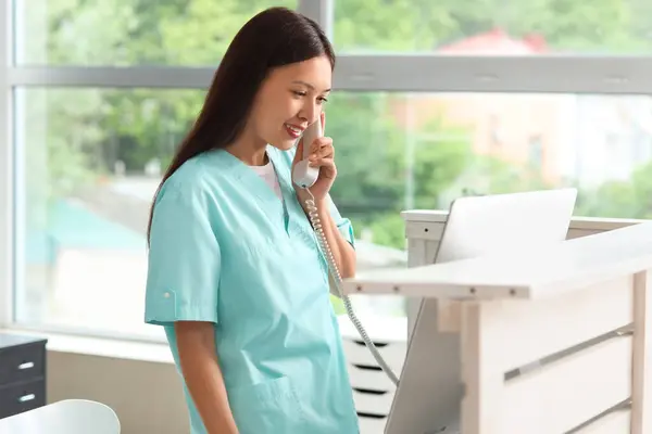 Medical receptionist managing clinic payments